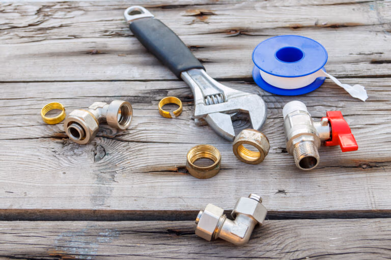 Various plumbing spare parts, sealing tape and adjustable wrench